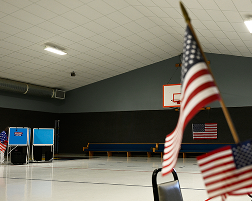 empty school gym with an American flag